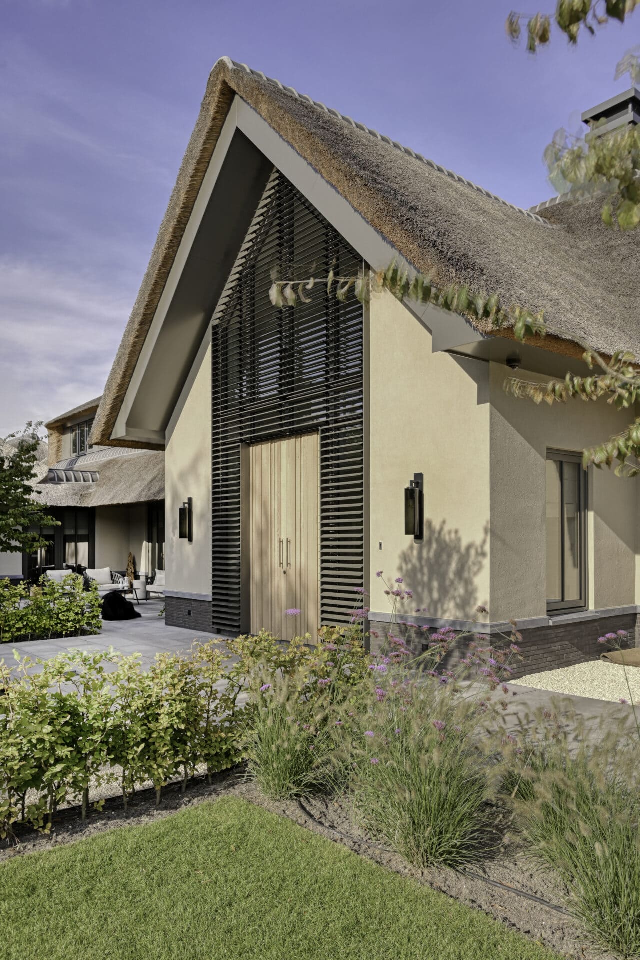 Landelijke villa met kantelbare lamellen tot in de nok om en rond de voordeur