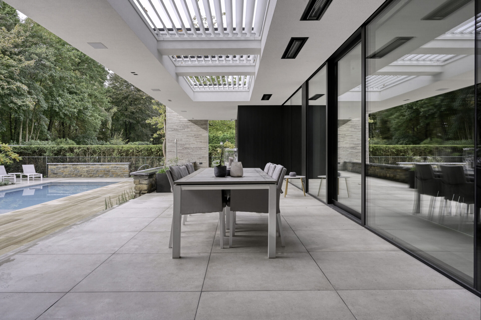 Modern terras met 3 inbouw lamellendaken in de inbouw boven het terras