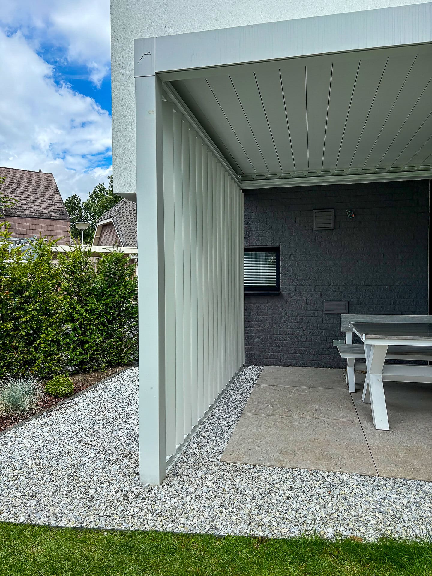 Close-up van verticale lamellenwand bij een terrasoverkapping