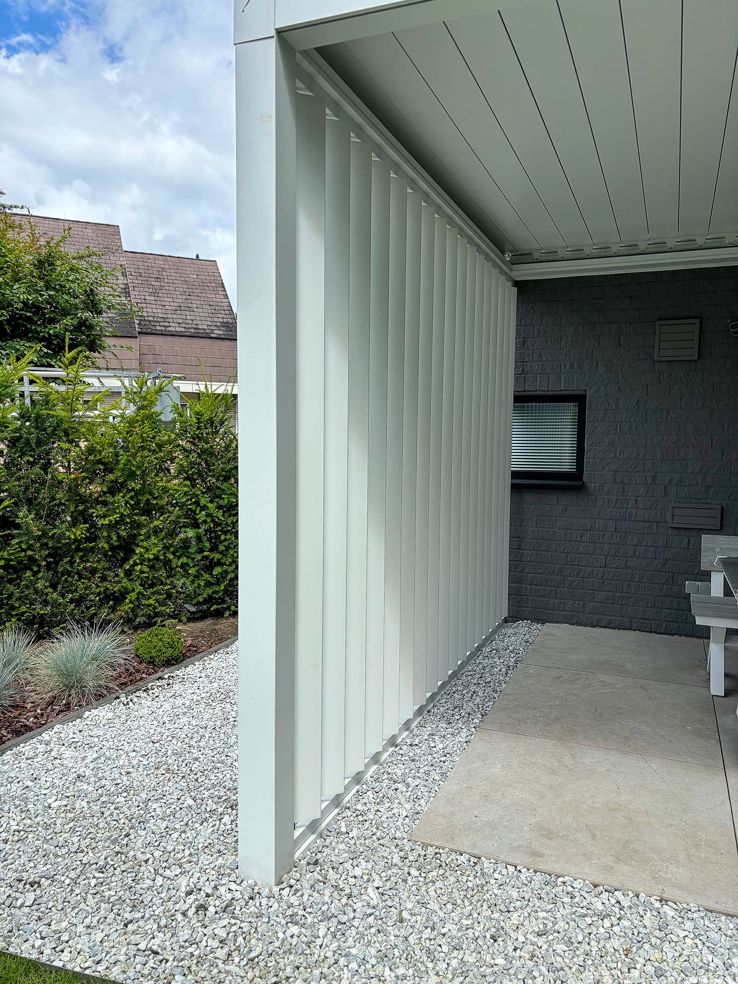 Close-up van verticale lamellenwand bij een terrasoverkapping