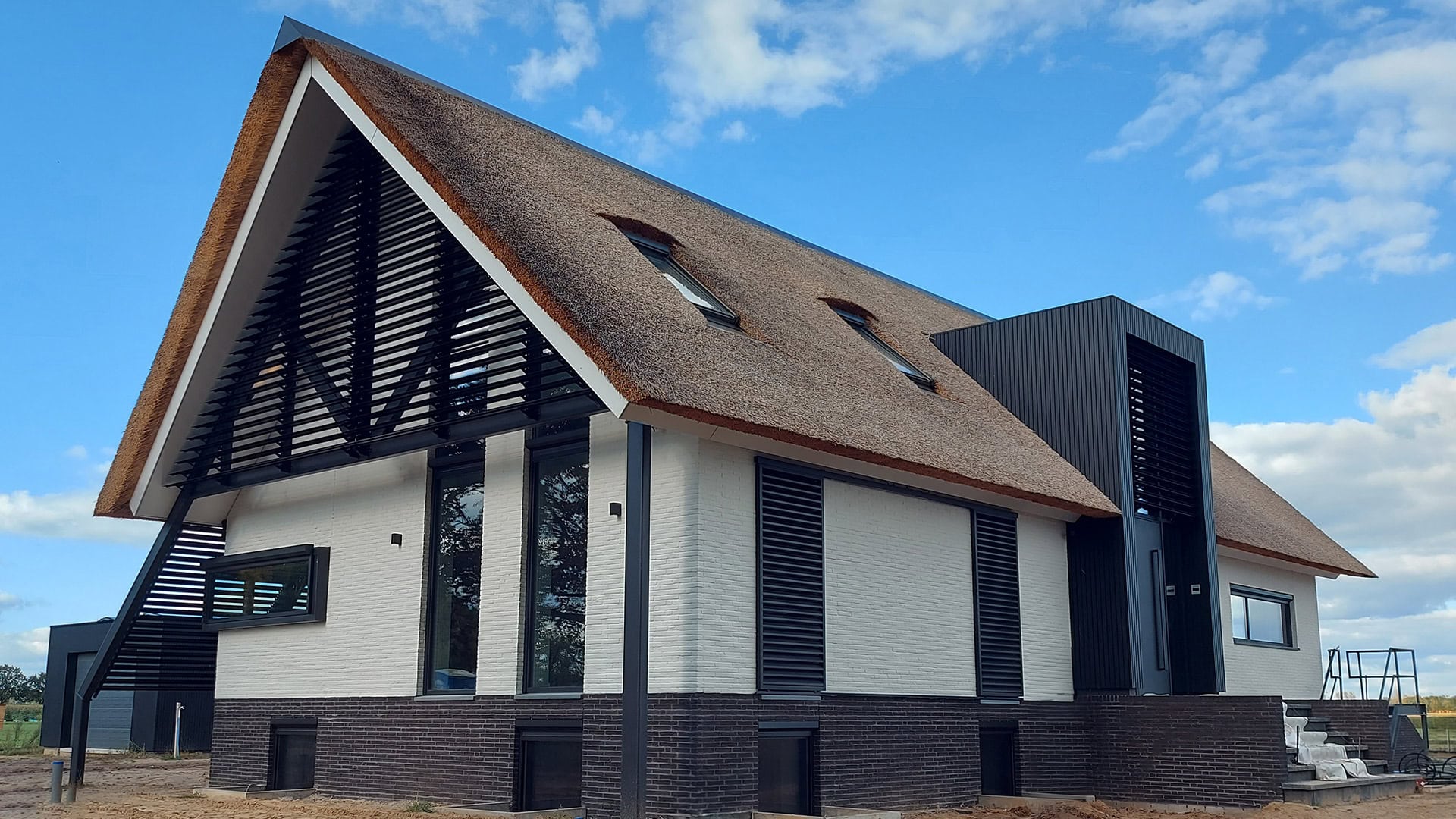 Moderne woonboerderij met kantelbare lamellen in de puntgevel