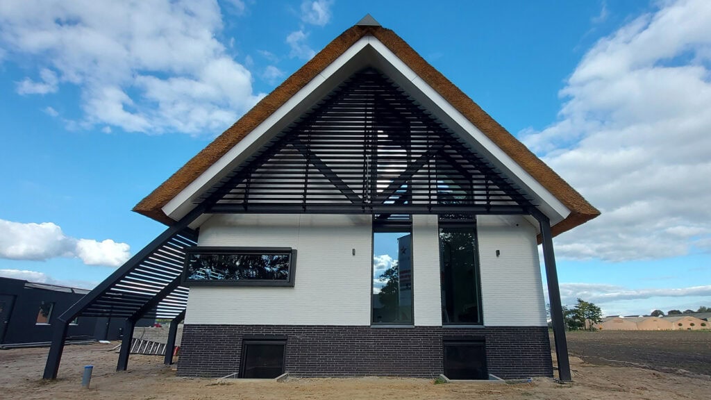 Moderne woonboerderij met kantelbare lamellen in de puntgevel