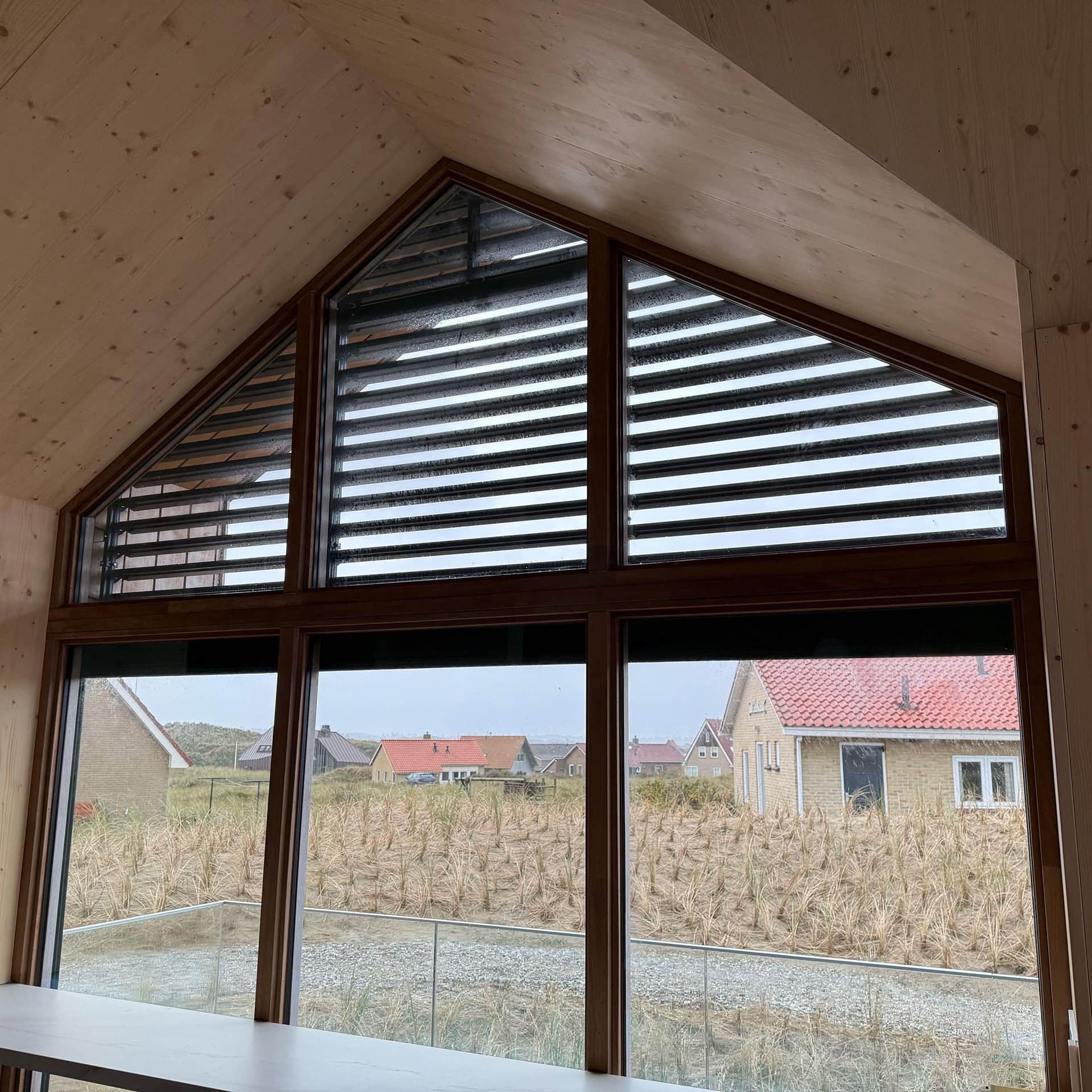 Binnenkant van een puntraam dat voorzien is van kantelbare lamellen